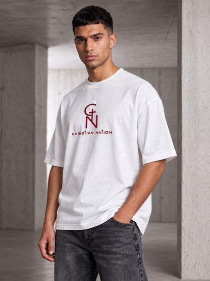 Christian Nation Banner T-Shirt in white, burgundy monogram across the chest, worn by a model (image 1 of 2)